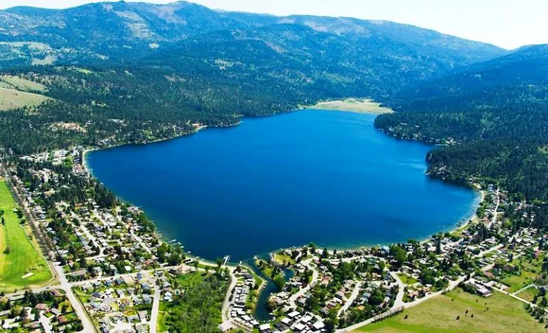 Aerial view of Liberty Lake with surrounding neighborhoods, golf fairways and forested hills in Liberty Lake, WA
